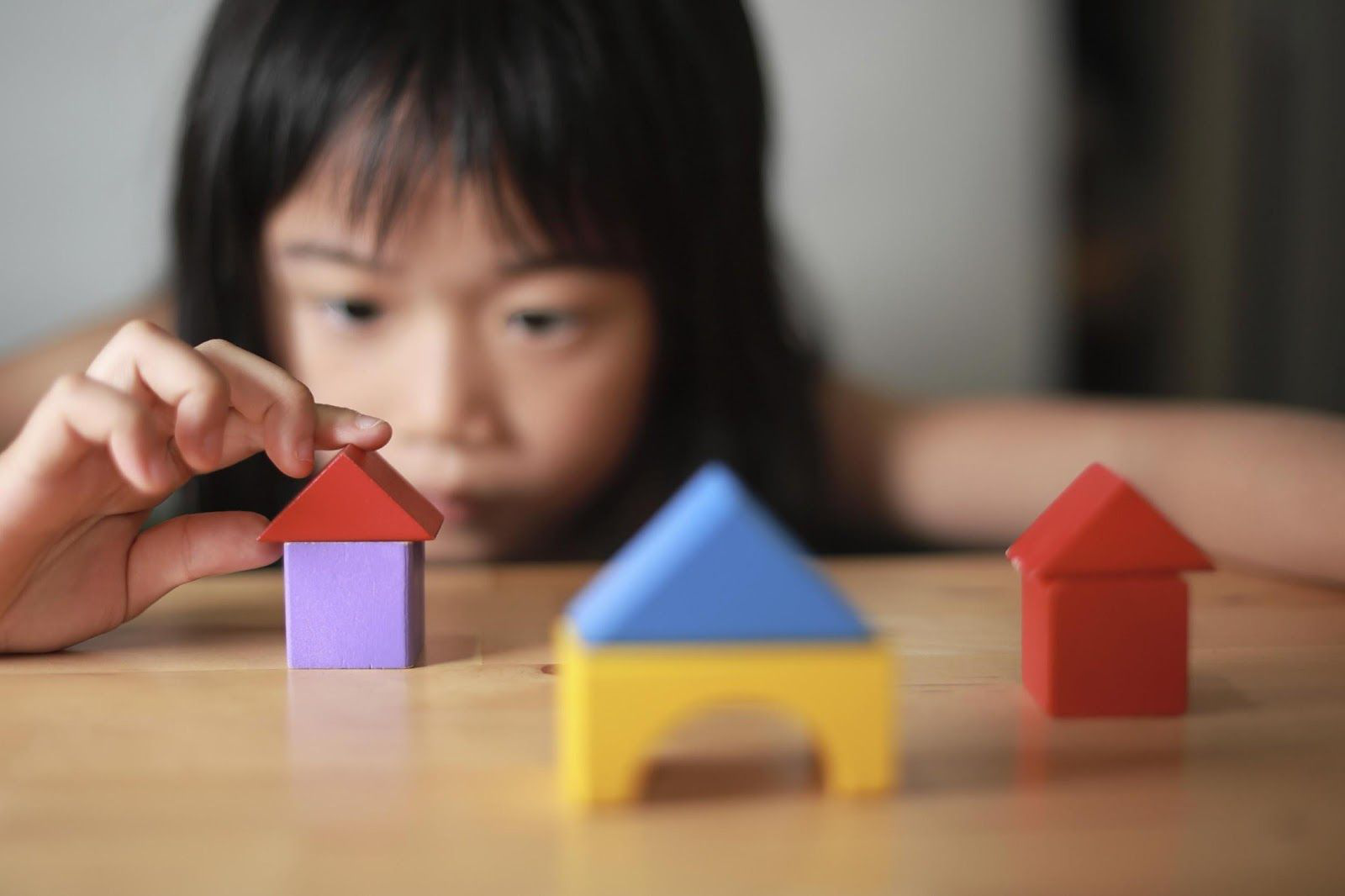 Flyer image showing a child playing with colorful geometric blocks