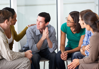 Man being counseled by group