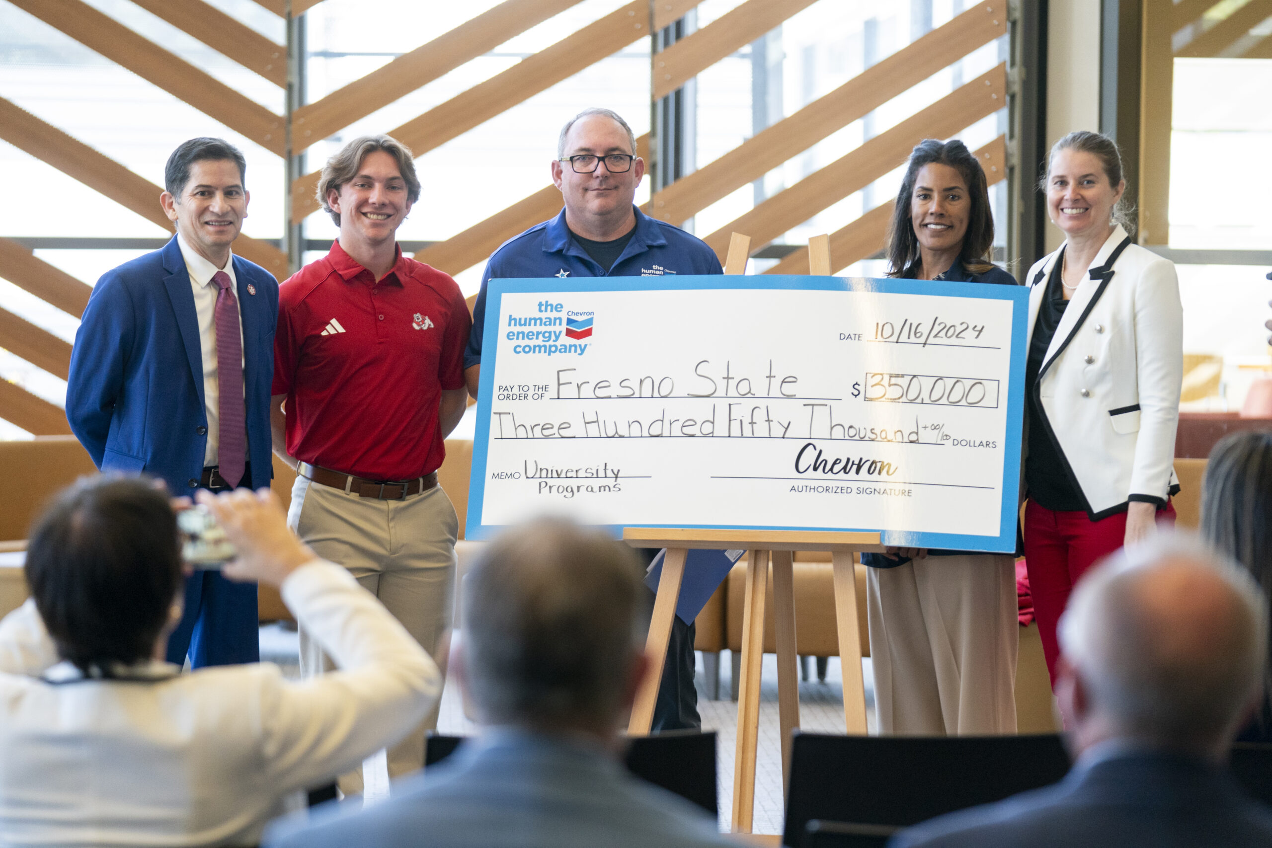 Chevron representative presents a check to Fresno State president and representatives.