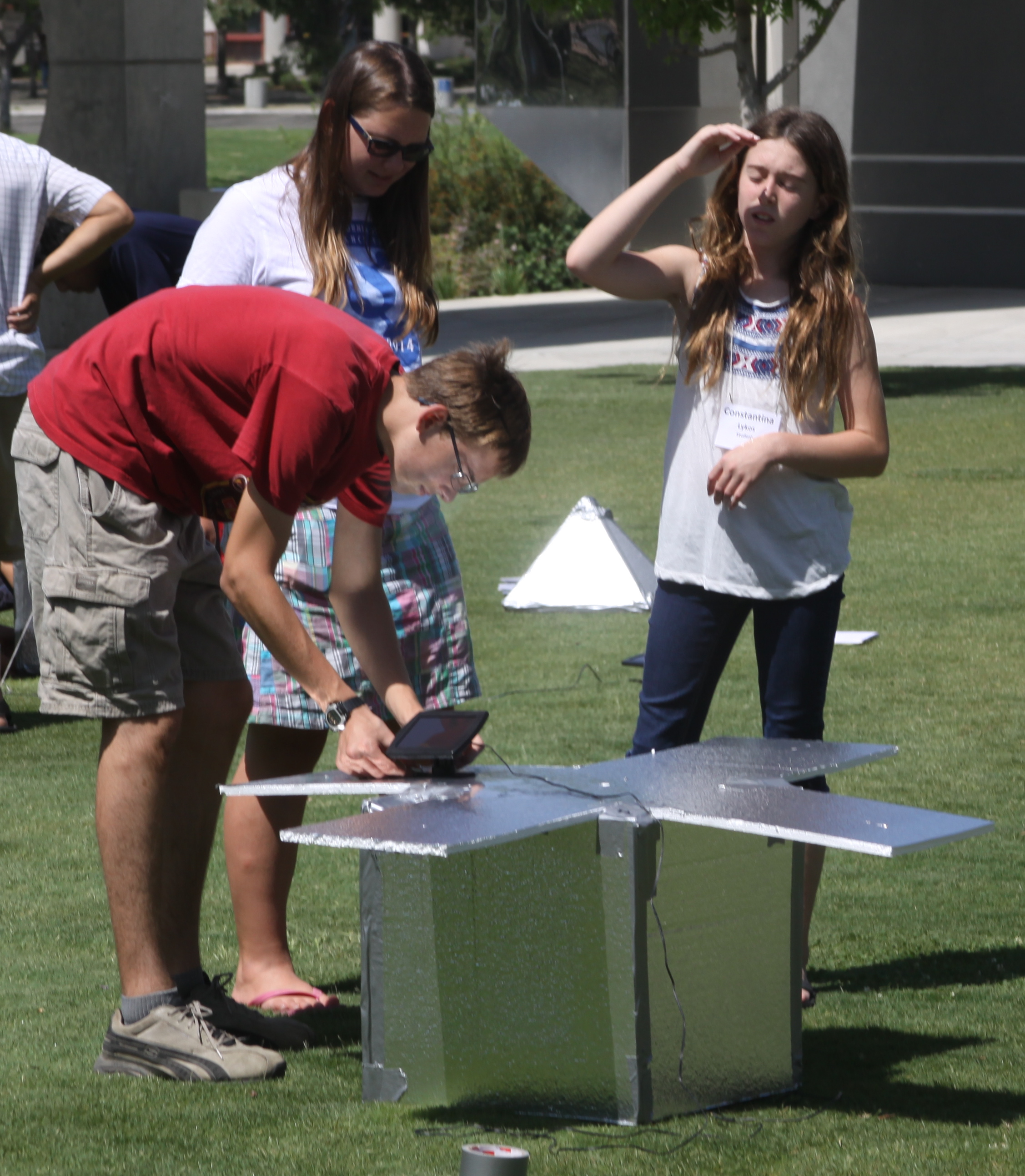 Flyer with students working outdoors, workshop benefits, workshop description, contact information, and registration fees