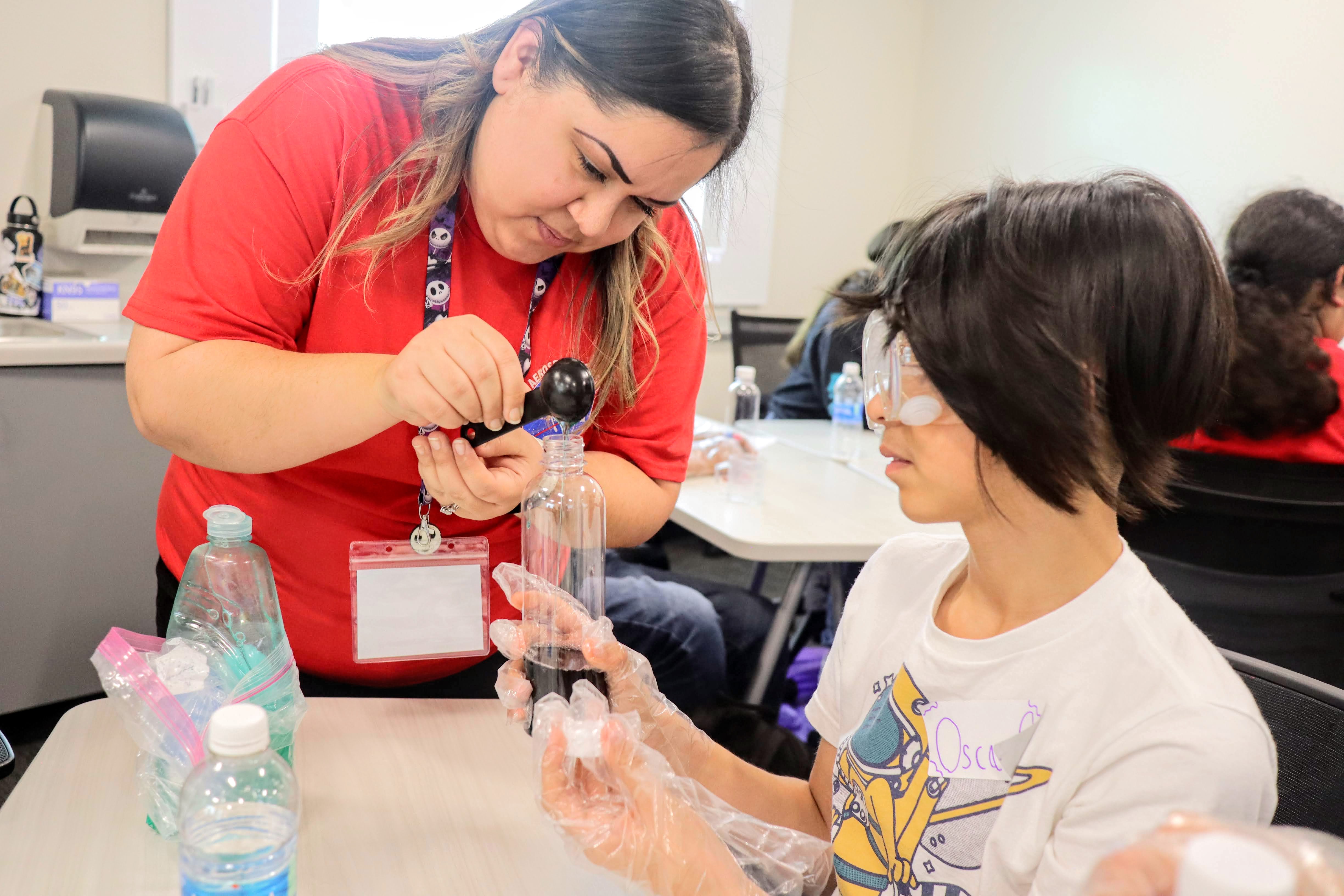 CBL tutor assisting a student in an experiment