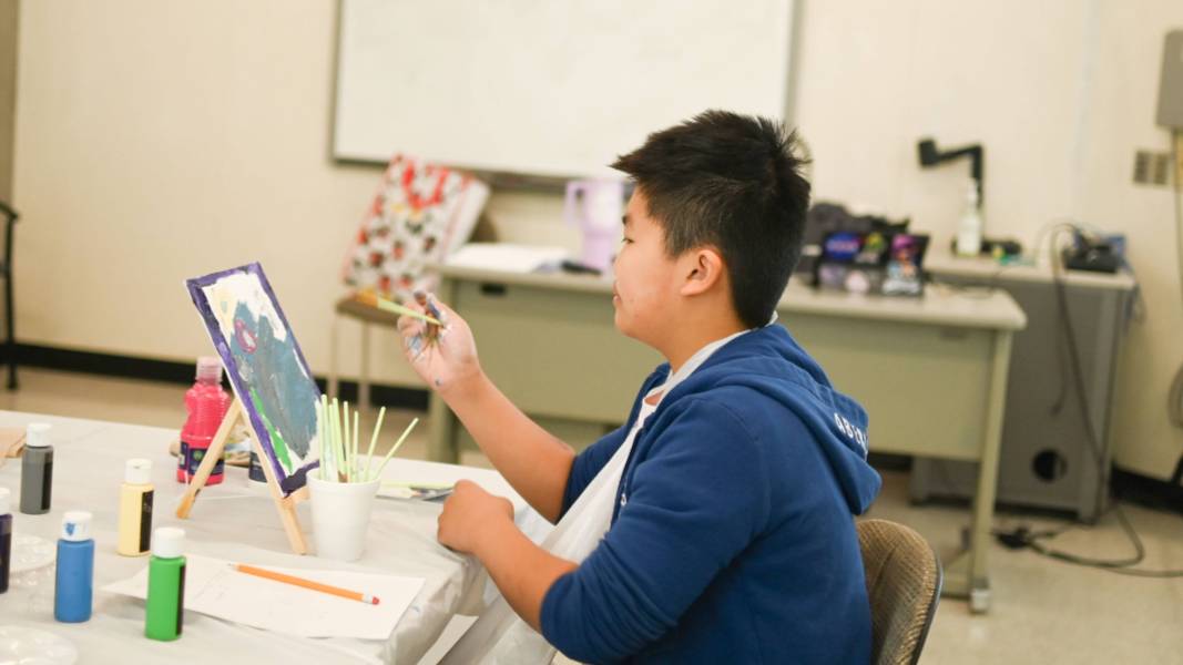 art student painting an abstract piece