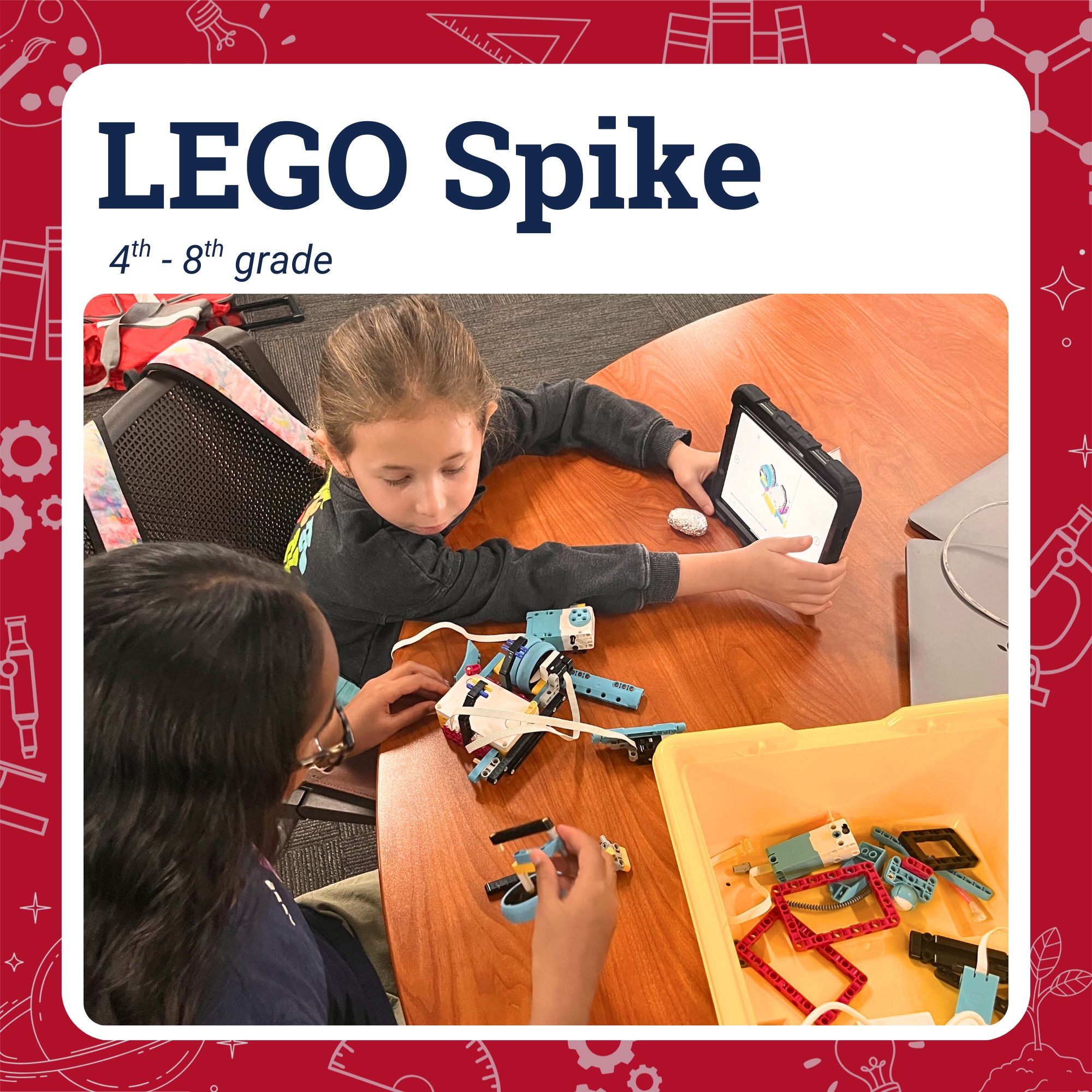 Two students working to build a LEGO spike project on a table top