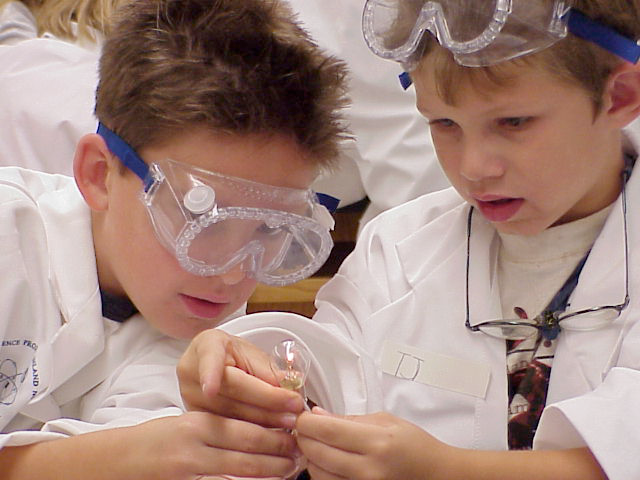 Student at a science lab station with goggles