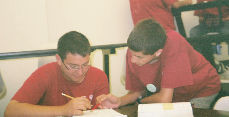 Brochure cover photo showing students working together with a HiMAP shirt visible