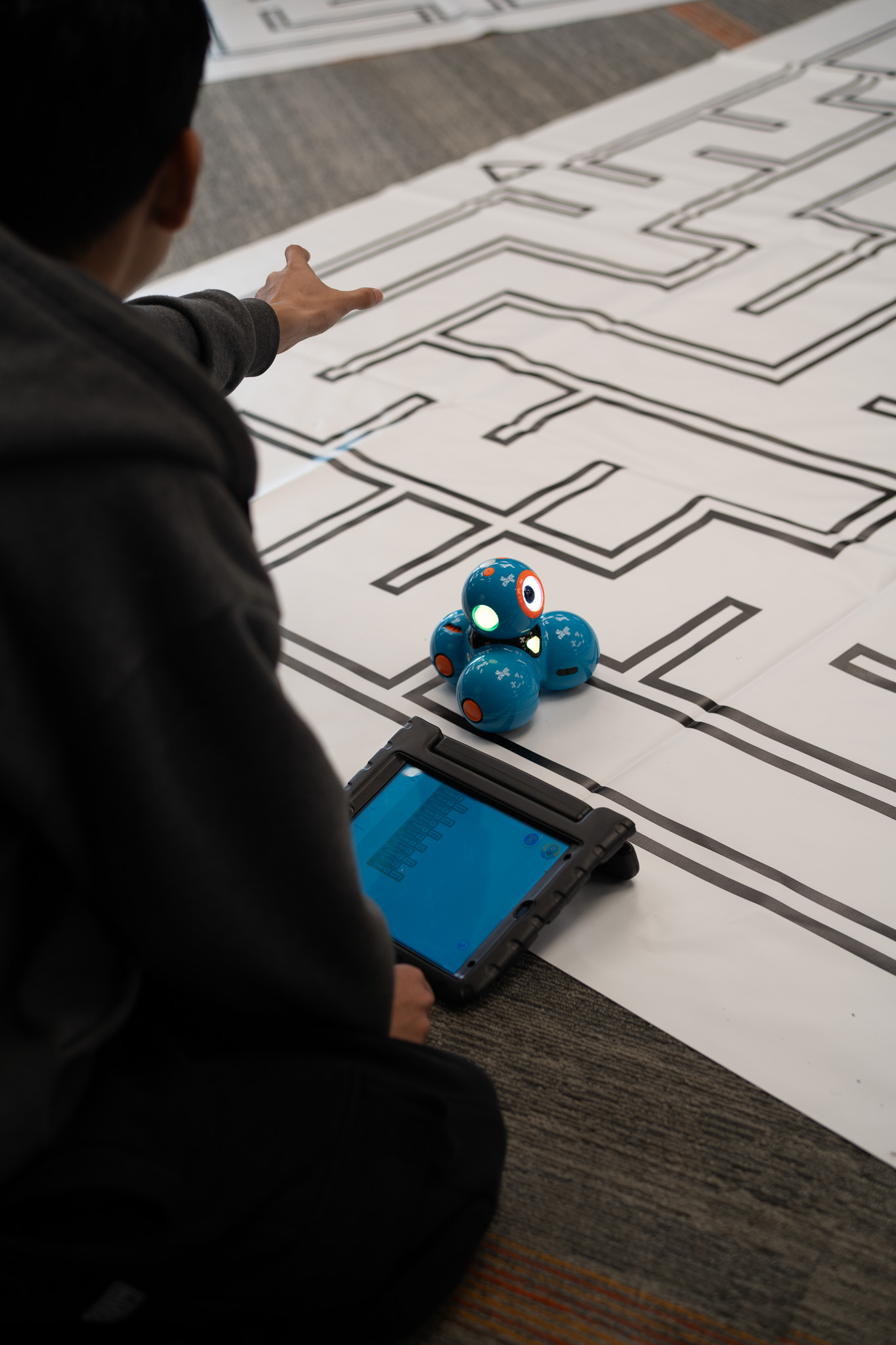 Students coding a robot through a maze