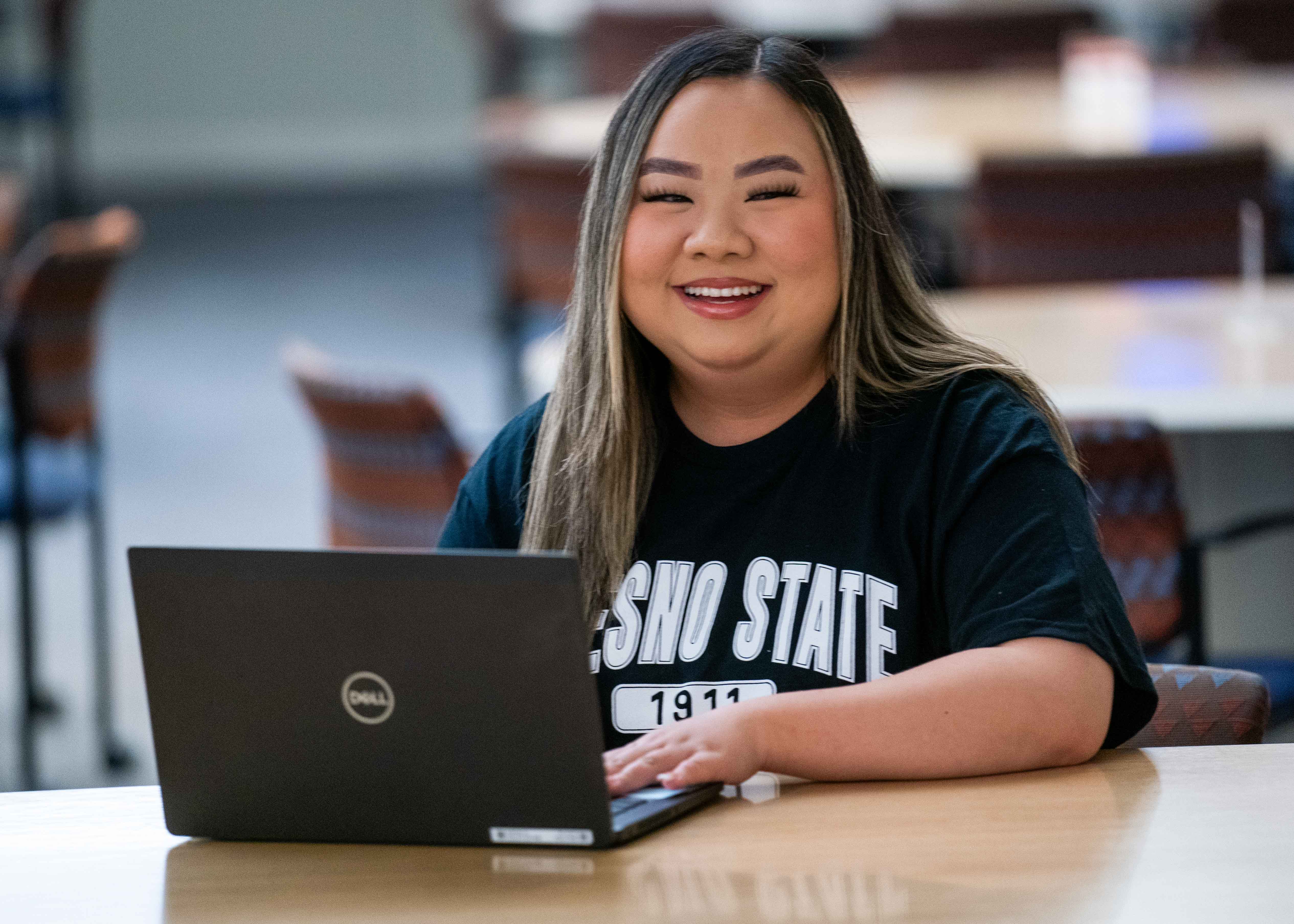 smiling student on a laptop
