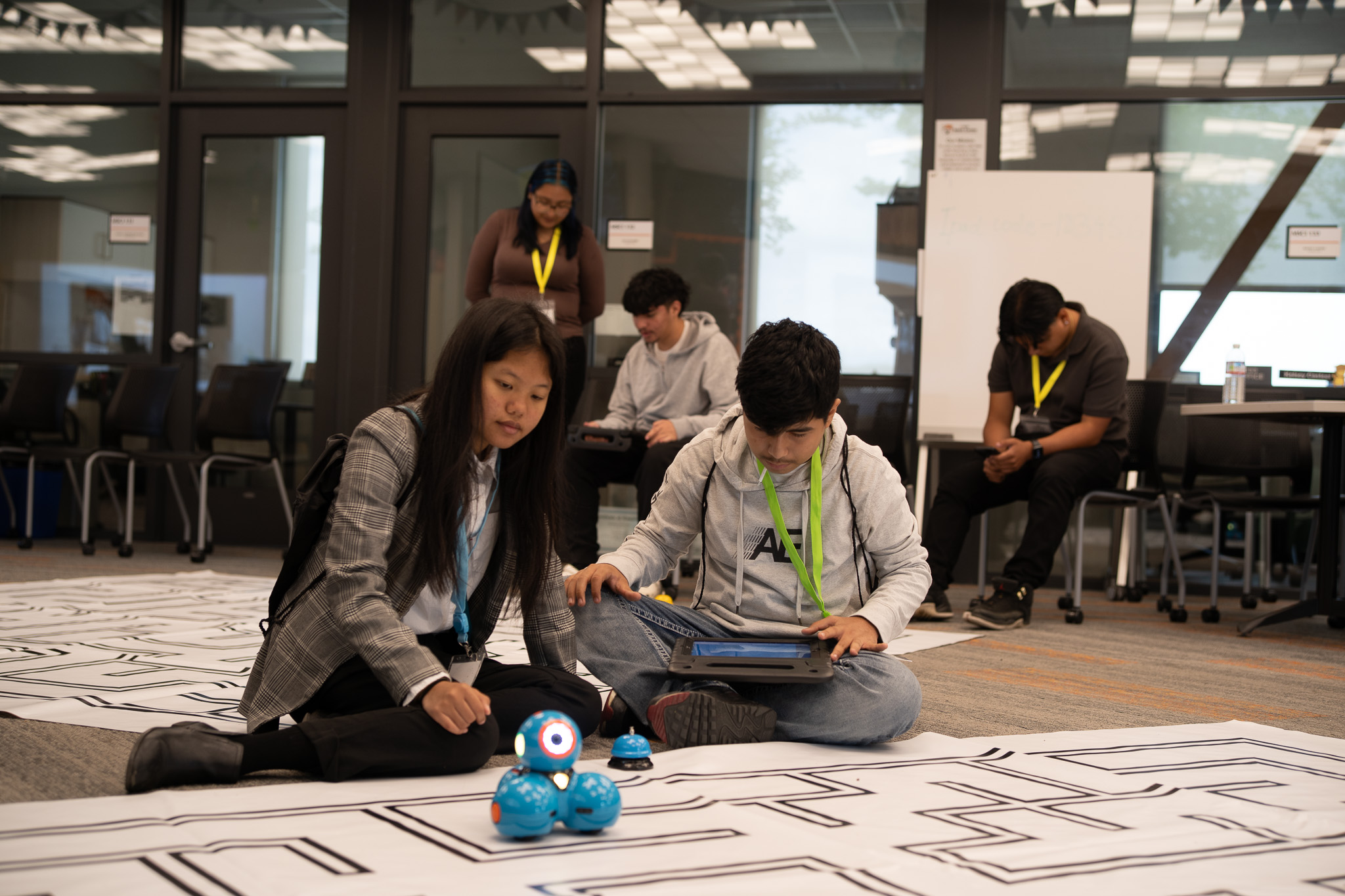 Students coding robot in classroom