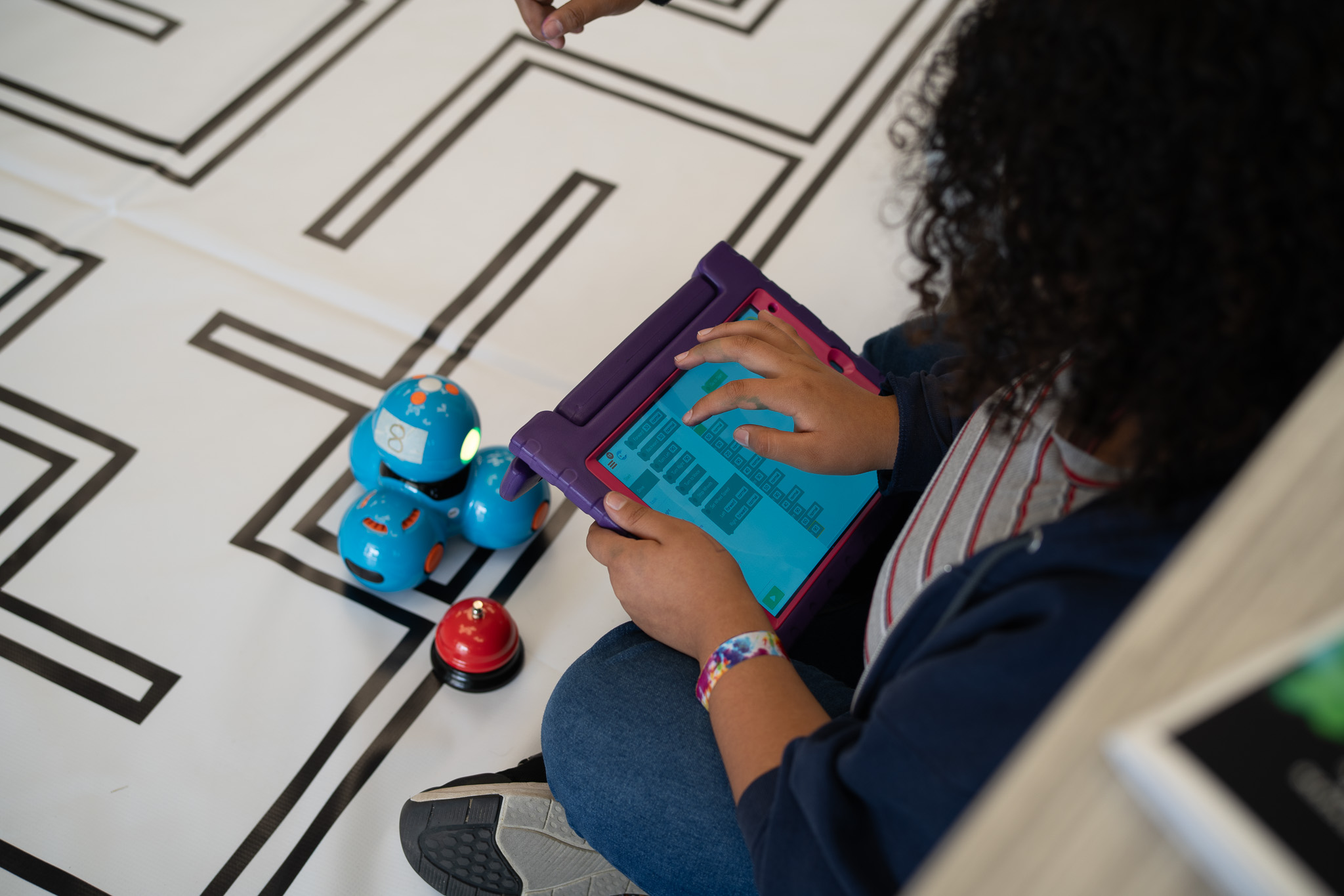 a student coding on an ipad. 