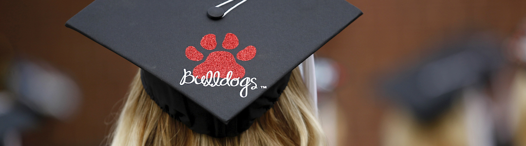 Graduation cap with red paw print and the word bulldogs