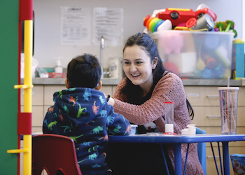 Female smiling at child