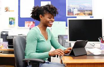 Female sitting at desk smiling