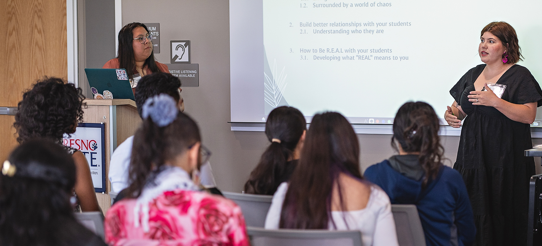 Program student and alumna presenting to a group of students