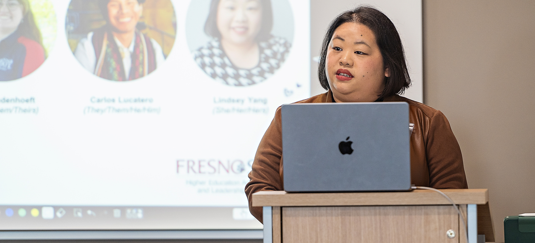 Presenter standing at podium with laptop