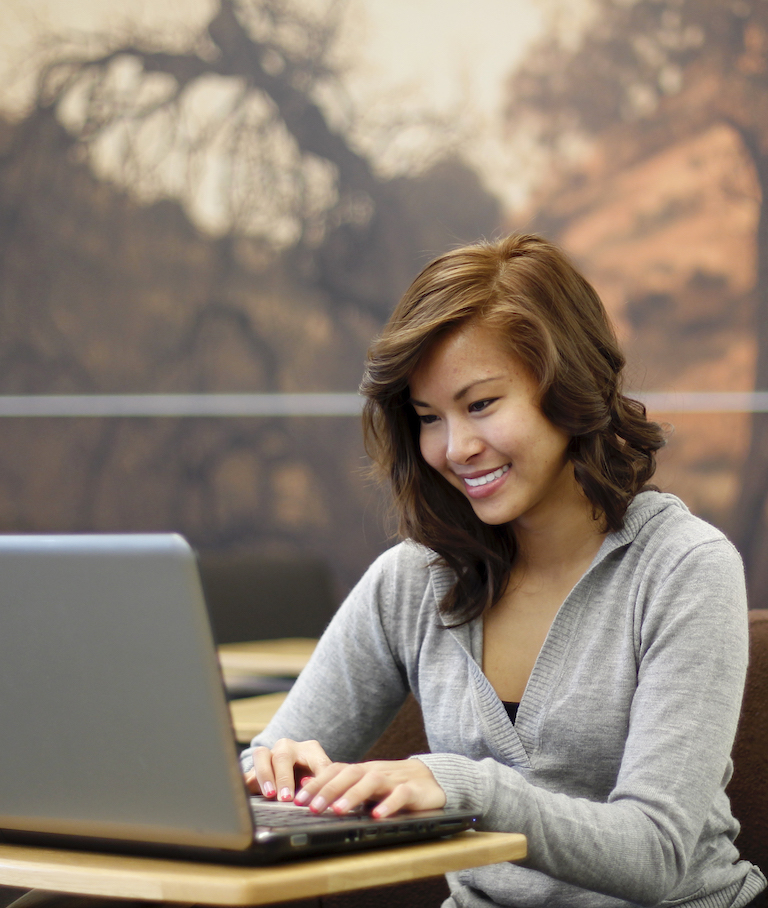 Student Typing on Laptop