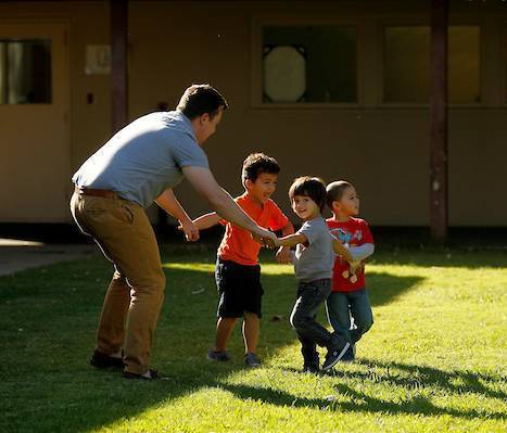 Children playing with teacher