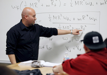 teacher pointing at whiteboard